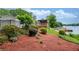 Well-landscaped backyard with a wooden deck, leading to a private waterfront with dock at 3125 Cardinal Lake Cir, Duluth, GA 30096