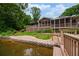 Home showcasing a backyard deck, gazebo and access to the lake at 3125 Cardinal Lake Cir, Duluth, GA 30096