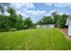 Expansive backyard with lush green lawn and mature trees, perfect for outdoor activities at 3125 Cardinal Lake Cir, Duluth, GA 30096