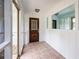 Cozy sunroom with tiled floor and a decorative front door at 3125 Cardinal Lake Cir, Duluth, GA 30096