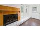 Living room showcasing a painted brick fireplace with stained mantle and black steel fireplace doors at 3125 Cardinal Lake Cir, Duluth, GA 30096