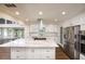 Gourmet kitchen featuring white cabinets, stainless appliances, and a large center island at 3125 Cardinal Lake Cir, Duluth, GA 30096