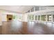 Spacious living area with hardwood floors, stone fireplace, and bright sunroom at 3125 Cardinal Lake Cir, Duluth, GA 30096