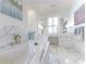 Luxurious bathroom boasting marble finishes, a soaking tub, and vanity with elegant fixtures and mirrors at 3450 Ridgewood Nw Rd, Atlanta, GA 30327