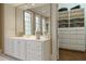 Elegant bathroom featuring double vanity, walk-in closet, and bright lighting at 3450 Ridgewood Nw Rd, Atlanta, GA 30327
