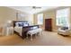 Cozy bedroom with natural light, carpeting, warm tones, and a comfortable bed perfect for relaxation at 3450 Ridgewood Nw Rd, Atlanta, GA 30327