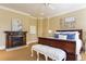 Inviting bedroom with a dark wooden fireplace, warm colored walls, and plush decor for a cozy retreat at 3450 Ridgewood Nw Rd, Atlanta, GA 30327