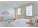 Cozy bedroom featuring bright white walls, two large windows, and white furnishings at 3450 Ridgewood Nw Rd, Atlanta, GA 30327