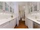 A bright butler's pantry featuring white cabinetry, marble countertops, and glass-front display cabinets at 3450 Ridgewood Nw Rd, Atlanta, GA 30327