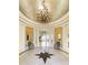 Grand foyer with marble floors, columns, and decorative chandelier at 3450 Ridgewood Nw Rd, Atlanta, GA 30327