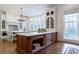 A spacious kitchen with two islands featuring countertops, custom cabinetry, and a chandelier at 3450 Ridgewood Nw Rd, Atlanta, GA 30327