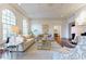 Elegant living room with large arched windows, hardwood floors, and classic white sofas at 3450 Ridgewood Nw Rd, Atlanta, GA 30327