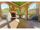 Covered patio features stone columns, a green ceiling, and a brick fireplace at 3450 Ridgewood Nw Rd, Atlanta, GA 30327