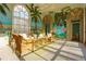 Bright sunroom with tropical mural, tile floor, and wicker furniture at 3450 Ridgewood Nw Rd, Atlanta, GA 30327