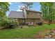 Spacious backyard with a patio set, grill, lush green grass and mature trees at 3470 Whisperwood Nw Ct, Marietta, GA 30064