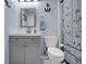 Charming bathroom with gray vanity, toilet, and a nautical-themed shower curtain at 3470 Whisperwood Nw Ct, Marietta, GA 30064