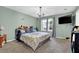 Bedroom with queen size bed, window view, ceiling fan, and mounted television at 3470 Whisperwood Nw Ct, Marietta, GA 30064