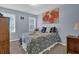 Cozy bedroom featuring a double bed, a large painting and dual windows for natural light at 3470 Whisperwood Nw Ct, Marietta, GA 30064