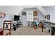 Bonus room with carpet flooring, a foosball table, tv, and a rocking chair by the window at 3470 Whisperwood Nw Ct, Marietta, GA 30064