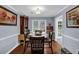 Elegant dining room with hardwood floors, wainscoting, and a large window for natural light at 3470 Whisperwood Nw Ct, Marietta, GA 30064