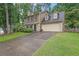 Charming two-story home featuring stone accents, a two-car garage, and a well-manicured front lawn at 3470 Whisperwood Nw Ct, Marietta, GA 30064