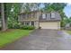 Charming two-story home featuring stone accents, a two-car garage, and a well-manicured front lawn at 3470 Whisperwood Nw Ct, Marietta, GA 30064