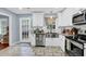 Modern kitchen featuring white cabinets, stainless steel appliances, and a stylish tile floor at 3470 Whisperwood Nw Ct, Marietta, GA 30064
