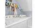Bright laundry area with white washer and dryer, and shelf for supplies at 3470 Whisperwood Nw Ct, Marietta, GA 30064