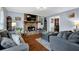 Cozy living room with a stone fireplace, hardwood floors, and comfortable seating at 3470 Whisperwood Nw Ct, Marietta, GA 30064