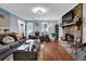 Spacious living room featuring hardwood floors, a stone fireplace, and bright, natural light at 3470 Whisperwood Nw Ct, Marietta, GA 30064