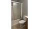 Bathroom features a shower-tub combo with glass doors and a standard toilet at 585 Station View Run, Lawrenceville, GA 30043