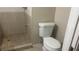 Compact bathroom with a tiled shower and a white standard toilet, showing a functional layout at 585 Station View Run, Lawrenceville, GA 30043