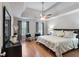 Comfortable bedroom featuring a tray ceiling, ceiling fan and stylish furnishings creating a relaxing retreat at 585 Station View Run, Lawrenceville, GA 30043