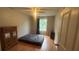 Bedroom featuring wood floors, neutral walls, ceiling fan and bright window at 585 Station View Run, Lawrenceville, GA 30043