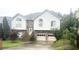 Charming two-story home boasts a brick-accented facade, symmetrical design, and a well-maintained front yard at 585 Station View Run, Lawrenceville, GA 30043