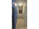 Hallway showcasing a side-by-side stainless steel refrigerator and access to the rear door at 585 Station View Run, Lawrenceville, GA 30043