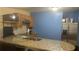 Modern kitchen includes a breakfast bar with granite countertops and stainless-steel appliances at 585 Station View Run, Lawrenceville, GA 30043
