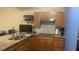 Kitchen features wooden cabinets, granite countertops, tile backsplash, and stainless appliances at 585 Station View Run, Lawrenceville, GA 30043