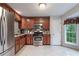 Updated kitchen features stainless steel appliances, granite countertops, and rich wood cabinets for a modern touch at 585 Station View Run, Lawrenceville, GA 30043