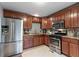 Modern kitchen with stainless steel appliances, custom cabinetry, and granite countertops exudes elegance and functionality at 585 Station View Run, Lawrenceville, GA 30043