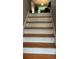 Staircase with wood treads and white risers leading to the upper floor, providing a classic and functional design at 585 Station View Run, Lawrenceville, GA 30043