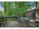 Spacious back deck with outdoor seating surrounded by lush greenery and mature trees at 2175 Fisher Ne Trl, Atlanta, GA 30345