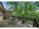 Back deck with outdoor seating surrounded by lush greenery and a wooded backyard at 2175 Fisher Ne Trl, Atlanta, GA 30345