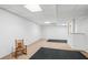 Unfinished basement area perfect for storage or potential customization with black rugs and a chair at 2175 Fisher Ne Trl, Atlanta, GA 30345