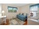 Bright bedroom with hardwood floors, two windows, and a daybed with blue bedding at 2175 Fisher Ne Trl, Atlanta, GA 30345