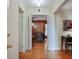 Hallway with wood floors leading into a living space and featuring bi-fold doors, a light fixture, and trim molding at 2175 Fisher Ne Trl, Atlanta, GA 30345