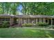 Charming brick home featuring wood shutters, a well-maintained lawn, and mature trees for shade and curb appeal at 2175 Fisher Ne Trl, Atlanta, GA 30345