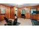 Spacious basement gym with wood paneled walls, a television, and exercise equipment at 2175 Fisher Ne Trl, Atlanta, GA 30345