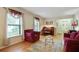 Formal living room offering hardwood floors, a piano, natural light from large windows, and a sitting area with elegant decor at 2175 Fisher Ne Trl, Atlanta, GA 30345