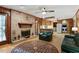 Living room featuring a brick fireplace, hardwood floors, and an open layout connecting to the kitchen for seamless entertaining at 2175 Fisher Ne Trl, Atlanta, GA 30345